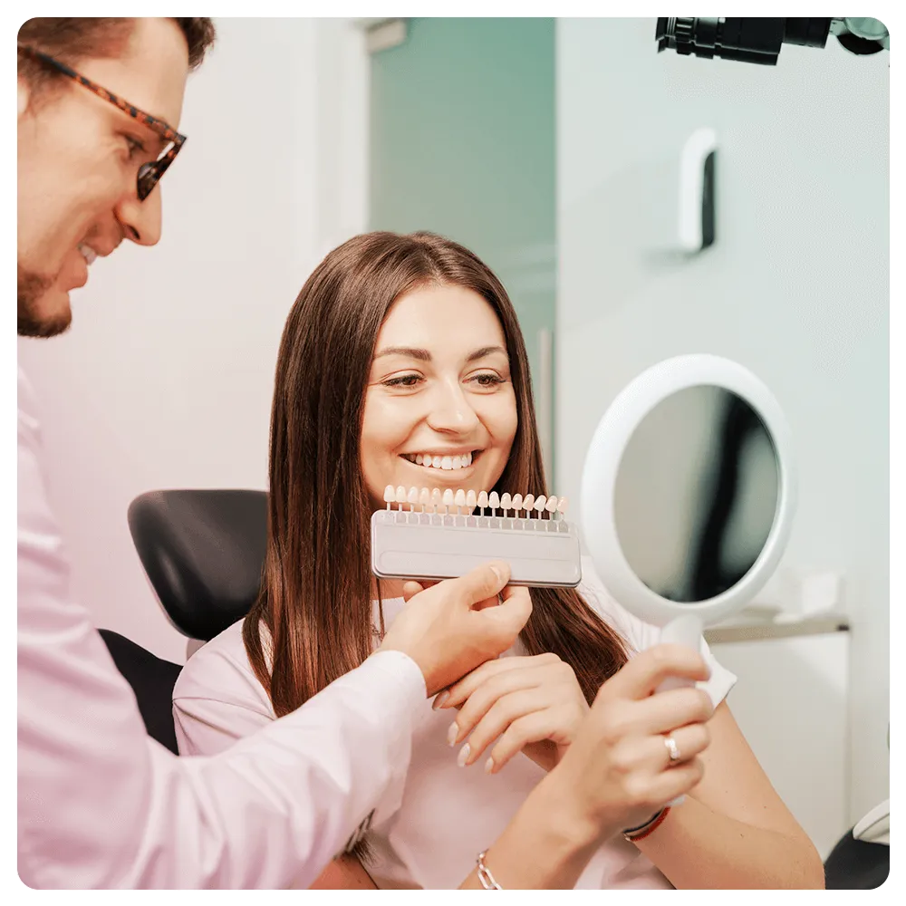 Patient looking into a mirror with veneers