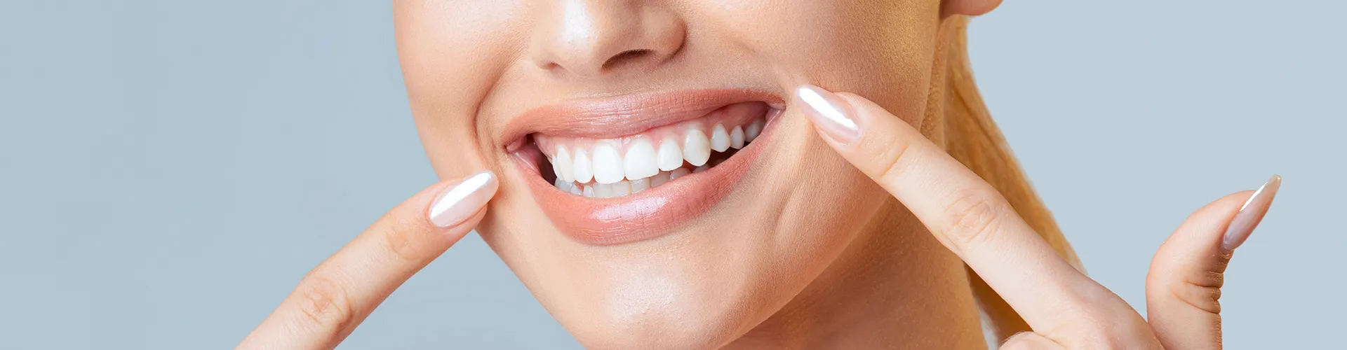 woman pointing at her smile