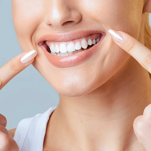woman pointing at her smile